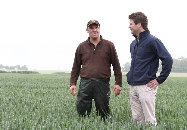 Two male farmers standing in a field